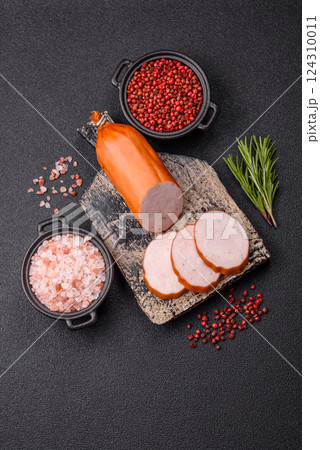 Delicious fresh ham cut into round slices with salt, spices and herbs 124310011
