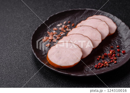 Delicious fresh ham cut into round slices with salt, spices and herbs 124310016
