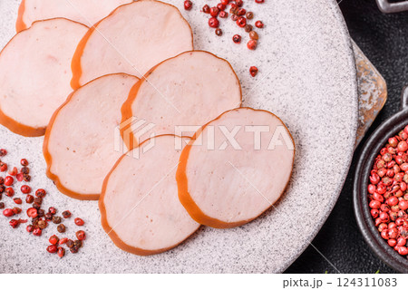 Delicious fresh ham cut into round slices with salt, spices and herbs 124311083