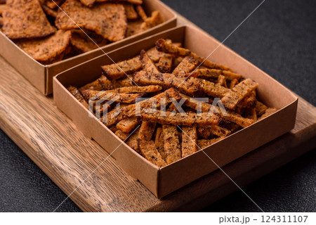 Crispy homemade brown bread crackers or croutons with seeds and grains Crispy homemade brown bread crackers or croutons with seeds and grains 124311107