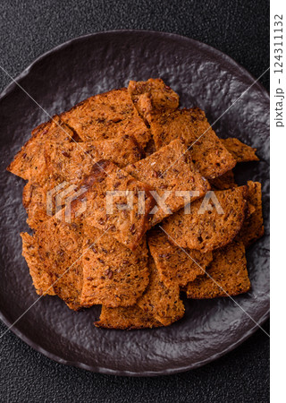 Crispy homemade brown bread chips with seeds and grains Crispy homemade brown bread chips with seeds and grains 124311132