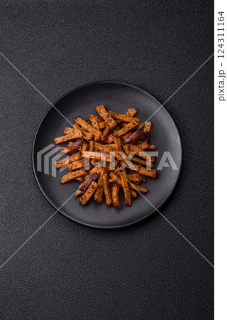 Crispy homemade brown bread crackers or croutons with seeds and grains 124311164