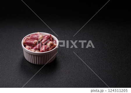 Raw chicken hearts with salt, spices and herbs 124311205