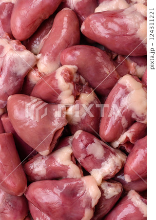 Raw chicken hearts with salt, spices and herbs 124311221