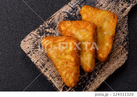 Hash browns with potatoes and onions, salt and spices Hash browns with potatoes and onions, salt and spices 124311320
