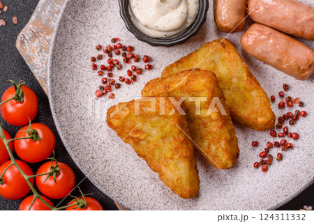 Hash browns with potatoes and onions, salt and spices Hash browns with potatoes and onions, salt and spices 124311332