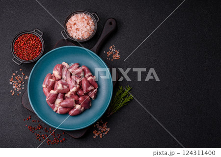 Raw chicken hearts with salt, spices and herbs 124311400