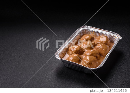 Meatballs with salt and spices in creamy caramel sauce 124311436