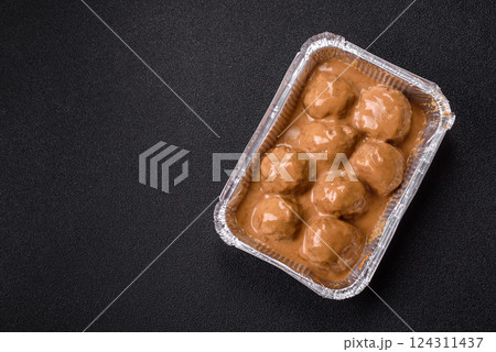 Meatballs with salt and spices in creamy caramel sauce 124311437