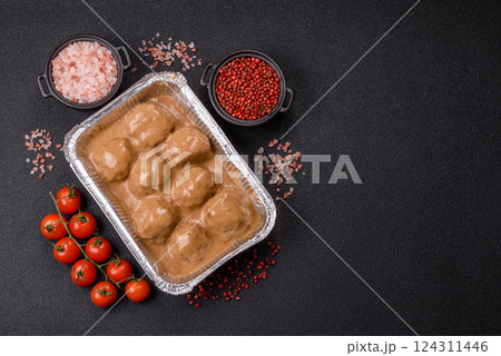 Meatballs with salt and spices in creamy caramel sauce 124311446