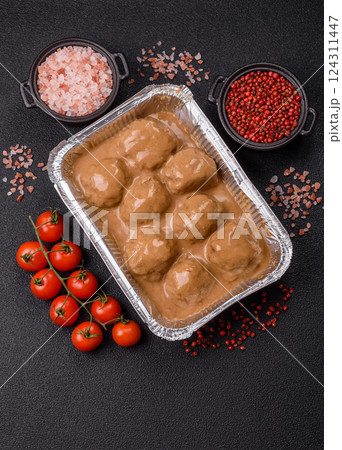 Meatballs with salt and spices in creamy caramel sauce 124311447