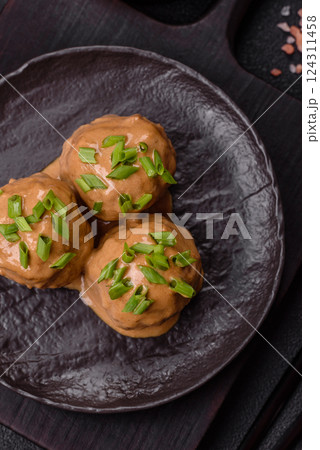 Meatballs with salt and spices in creamy caramel sauce Meatballs with salt and spices in creamy caramel sauce 124311458
