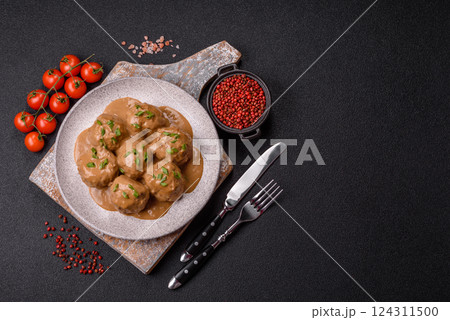 Meatballs with salt and spices in creamy caramel sauce Meatballs with salt and spices in creamy caramel sauce 124311500