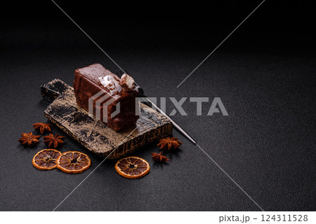 Piece of sweet chocolate bounty cake with coconut flakes and sponge Piece of sweet chocolate bounty cake with coconut flakes and sponge 124311528