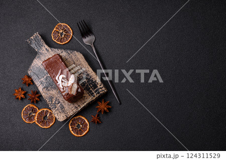 Piece of sweet chocolate bounty cake with coconut flakes and sponge Piece of sweet chocolate bounty cake with coconut flakes and sponge 124311529