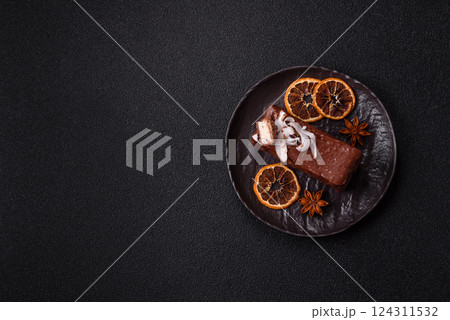 Piece of sweet chocolate bounty cake with coconut flakes and sponge 124311532