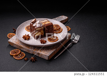 Piece of sweet chocolate bounty cake with coconut flakes and sponge Piece of sweet chocolate bounty cake with coconut flakes and sponge 124311551