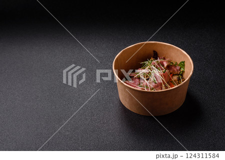 Warm salad consisting of slices of roast beef, greens, tomatoes, cucumbers, green beans Warm salad consisting of slices of roast beef, greens, tomatoes, cucumbers, green beans 124311584