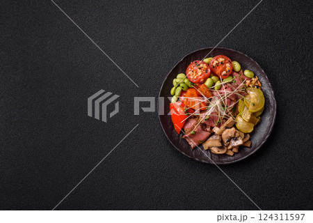Warm salad consisting of slices of roast beef, greens, tomatoes, cucumbers, green beans Warm salad consisting of slices of roast beef, greens, tomatoes, cucumbers, green beans 124311597