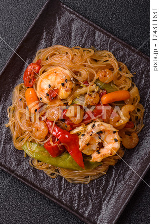 Glass noodles with shrimps and seafood, vegetables, spices and soy sauce Glass noodles with shrimps and seafood, vegetables, spices and soy sauce 124311631
