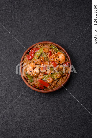Glass noodles with shrimps and seafood, vegetables, spices and soy sauce 124311660