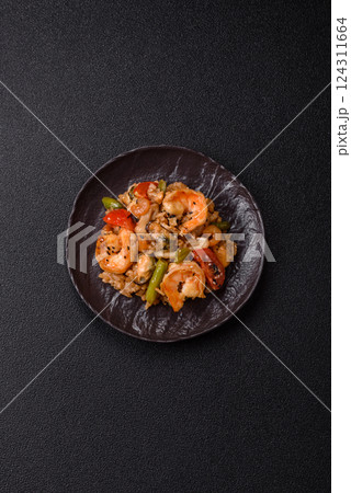 Rice with shrimps and seafood, vegetables, spices and soy sauce 124311664