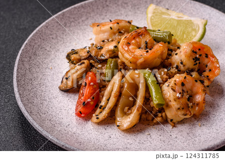 Rice with shrimps and seafood, vegetables, spices and soy sauce 124311785