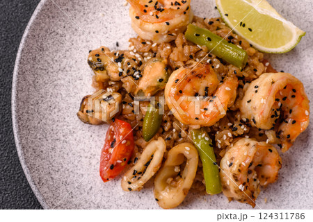 Rice with shrimps and seafood, vegetables, spices and soy sauce Rice with shrimps and seafood, vegetables, spices and soy sauce 124311786