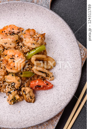 Rice with shrimps and seafood, vegetables, spices and soy sauce 124311789