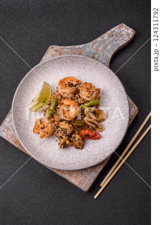 Rice with shrimps and seafood, vegetables, spices and soy sauce 124311792