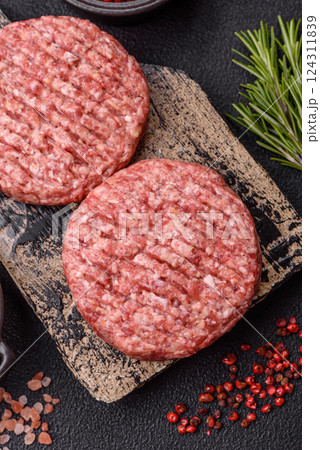 Fresh raw ground beef burger patty with salt and spices Fresh raw ground beef burger patty with salt and spices 124311839