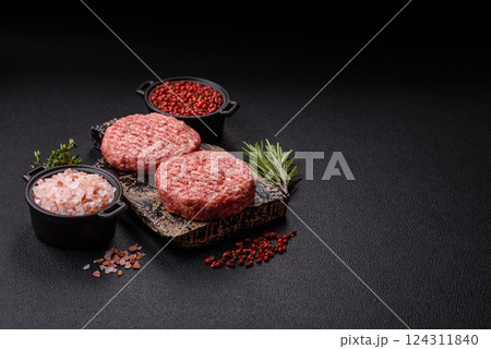 Fresh raw ground beef burger patty with salt and spices 124311840