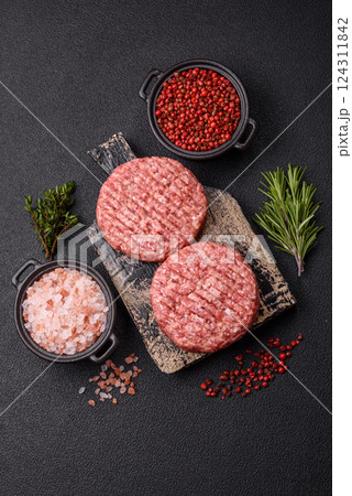 Fresh raw ground beef burger patty with salt and spices Fresh raw ground beef burger patty with salt and spices 124311842