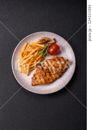 Delicious fresh grilled chicken fillet with spices and herbs Delicious fresh grilled chicken fillet with spices and herbs 124311891