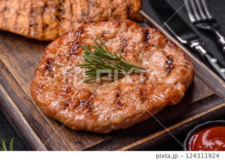 Delicious fresh grilled turkey fillet with spices and herbs Delicious fresh grilled turkey fillet with spices and herbs 124311924