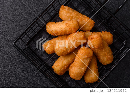 Delicious crispy cheese sticks with mozzarella, salt and spices 124311952