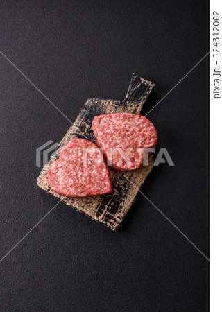 Raw beef or pork burger patty in the shape of a heart 124312002