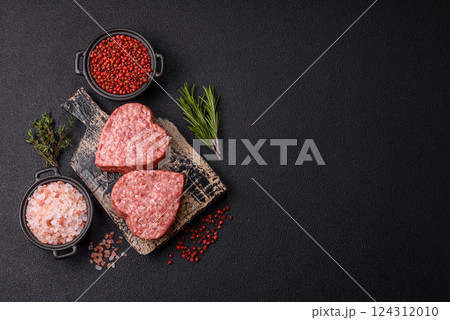 Raw beef or pork burger patty in the shape of a heart Raw beef or pork burger patty in the shape of a heart 124312010