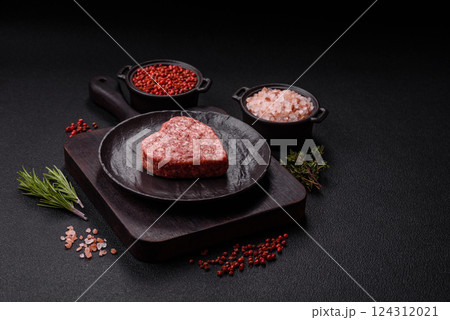 Raw beef or pork burger patty in the shape of a heart Raw beef or pork burger patty in the shape of a heart 124312021