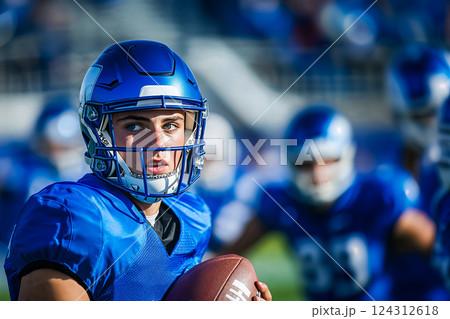 Football player preparing to throw ball, portrait of focused young man playing American football, dynamic moment of school American football match, copy space for sport and healthy lifestyle concept 124312618