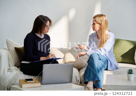 Young woman patient in mental session talking with professional psychologist Young woman patient in mental session talking with professional psychologist 124312721