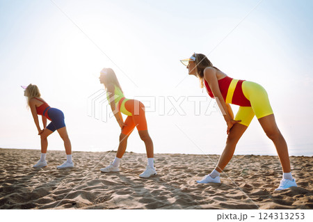 Smiling dancers in colorful swimsuits are dancing on beach ?oncept of sports, aerobics. Active sport Smiling dancers in colorful swimsuits are dancing on beach ?oncept of sports, aerobics. Active sport 124313253