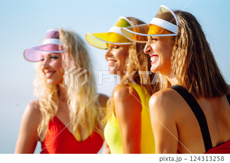 Smiling dancers in colorful swimsuits are dancing on beach ?oncept of sports, aerobics. Active sport 124313258