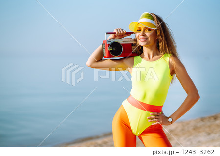 Smiling dancers in colorful swimsuits are dancing on beach ?oncept of sports, aerobics. Active sport Smiling dancers in colorful swimsuits are dancing on beach ?oncept of sports, aerobics. Active sport 124313262