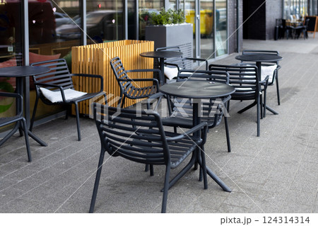 Outdoor street cafe tables ready for service. Empty cafe terrace with table and plastic chair, morning time. Food concept 124314314