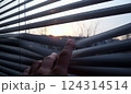 Staying at home, quarantine, looking at a sunset through the blinds background 124314514