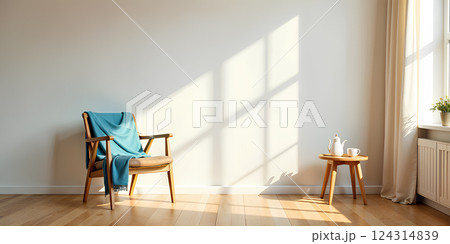 A minimalist, bright living room interior featuring an armchair against a clean white wall. A minimalist, bright living room interior featuring an armchair against a clean white wall. 124314839