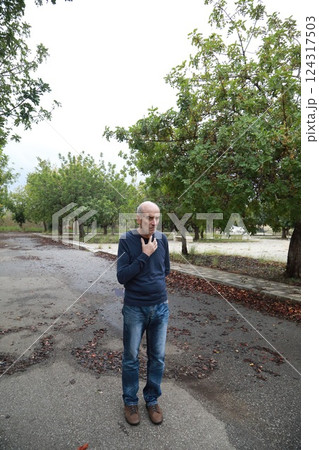 Uncomfortable Elderly Man Cannot Walk In Natural Park Under Trees 124317503
