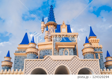 roof of a beautiful fantastic fairy tale castle in the Magic City amusement park in Tashkent in Uzbekistan on the background of the blue sky 124320294