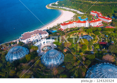 Luxury hotel at sea with sandy beach in Hon Tre island in Vinpearl park in Nha Trang in Vietnam, top aerial view. A resort in Asia for summer vacation Luxury hotel at sea with sandy beach in Hon Tre island in Vinpearl park in Nha Trang in Vietnam, top aerial view. A resort in Asia for summer vacation 124320324